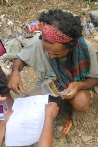 An Iraya man affixing his thumbmark in the assessment form after the interview during the Habagat Special Validation in Sitio Lagnas, Lumangbayan Abra de Ilog, Occidental Mindoro
