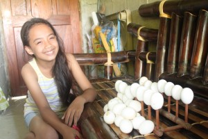 Shemiah smiles while posing with the eggshells she collected from her baon. She will use the waste product to create an artistic piece from it.