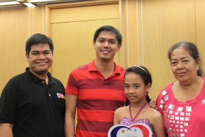 Pantawid Pamilya Regional Program Coordinator Vincent Dominic Obcena and National Deputy Program Manager Wadel Cabrera strike a pose with Shemiah Pineda and her grandmother, Melania Mendoza, after receiving the national award.