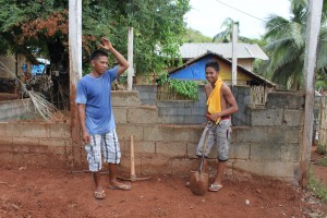 Father and son, Renante and Rayniel work together to build a foundation for their new abode. 