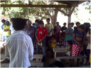 An IP volunteer-facilitator leads an opening prayer to start their Family Development Session in Sitio Talapa, Barangay Talabaan, Mamburao, Occidental Mindoro.