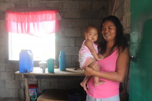 Ronalyn welcomes her visitors with a smile to their newly-built home.
